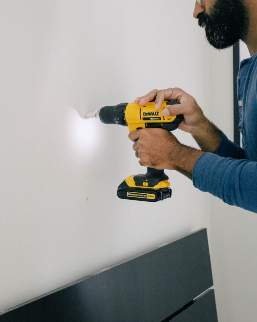 Ravalement de façade à Amiensperson holding yellow and black cordless hand drill